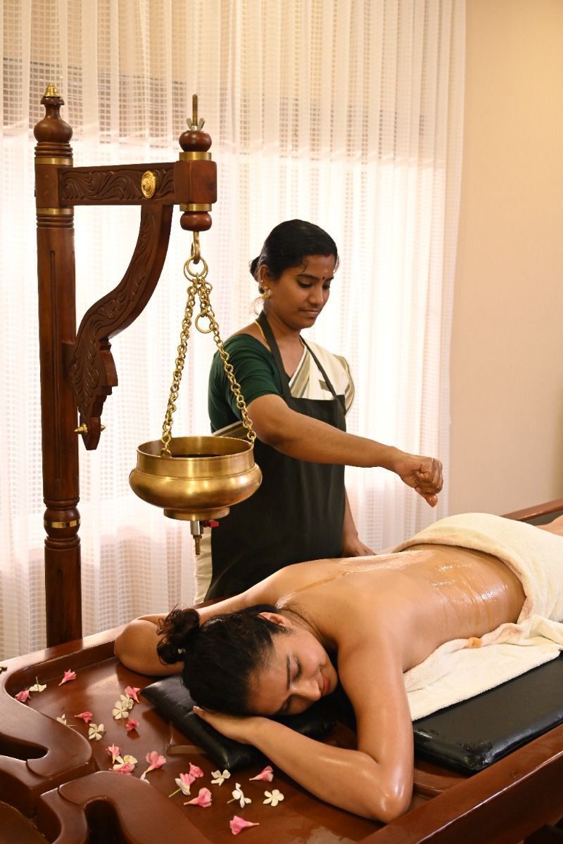 A traditional Kerala herbal treatment being prepared